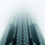 A skyscraper disappearing into the fog