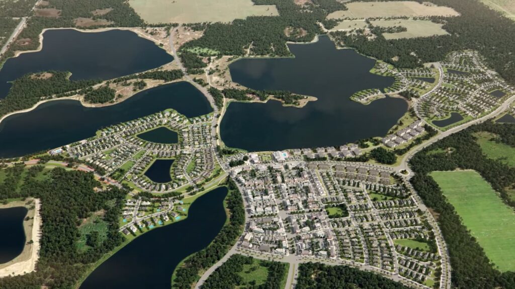 An aerial view of a planned community with lakes and winding roads